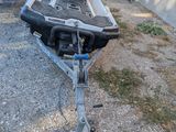 a boat that is sitting on a trailer in the yard