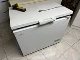 a white refrigerator sitting in the corner of a kitchen