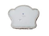 a small white plate with a blue flower on it