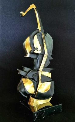 black and gold sculpture of a violin on a black background