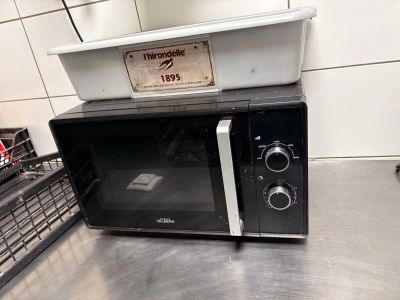 a microwave sitting on top of a counter in a kitchen