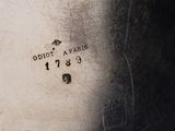 a close up of a silver plate with a number on it