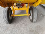 a close up view of a yellow tractor with wheels