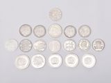 an image of a pile of silver coins on a white surface