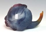 a blue and purple figurine of a fish with a tag on it
