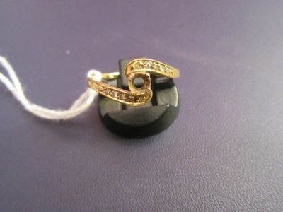 a black button with a gold ring on top of it