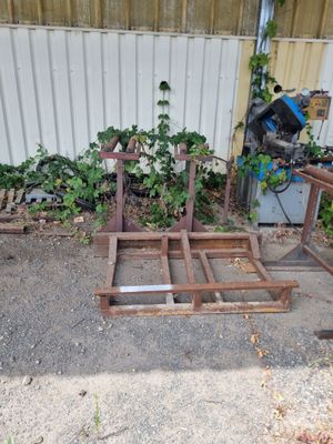 two pieces of wood sitting on the ground next to a building