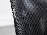 a close up of a black chair with a hole in the back