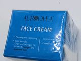 a close up of a box of face cream on a white surface