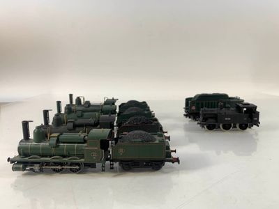 three green trains on a white surface with a white background