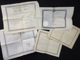 some old papers are laying on top of a table