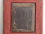 a picture of a red picture frame on a table
