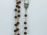 a rosary with a cross on it sitting on a table