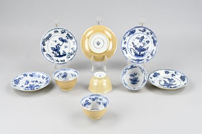 a group of blue and white plates and bowls on a table