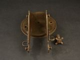 a small metal object on a table with a small object in the middle
