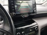 a picture of a car dashboard with a monitor and steering wheel