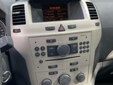 the interior of a car with a steering wheel and dashboard controls