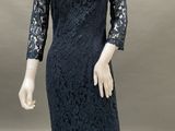 an image of a mannequin wearing a blue dress with lace on it