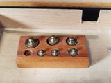 a small wooden box with a bunch of bells inside of it
