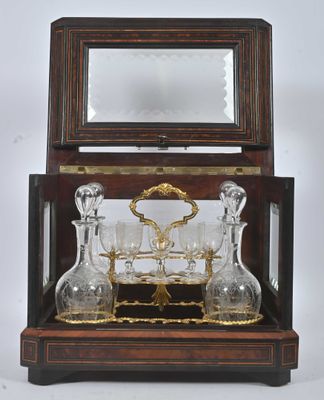 a glass set in a wooden box with a mirror