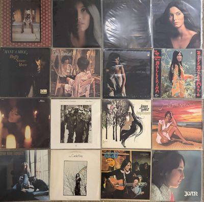 a lot of records on the wall of a room