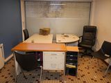 an image of a small office with a desk and chairs