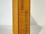 an old book sitting on top of a table next to a white wall