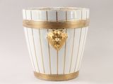 a white and gold vase with a lion head on it