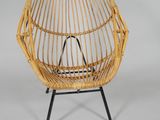 an image of a wicker chair with a black metal frame