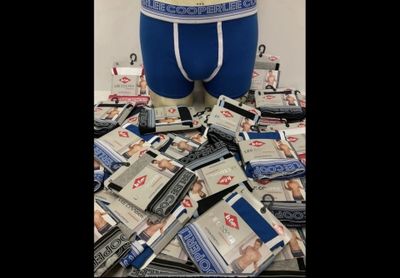 a pile of money sitting on top of a pile of underwear
