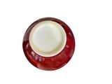 a red and white plate with a red rim on a white background