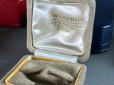 a box with a ring inside of it sitting on a table