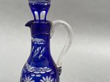 an image of a blue and white glass vase with flowers on it