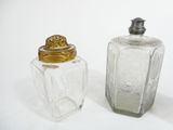 two salt and pepper shakers sitting next to each other