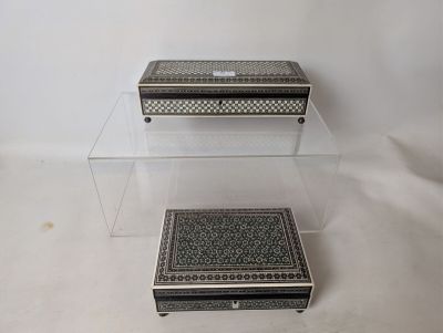 two clear boxes sitting on top of each other on a white surface