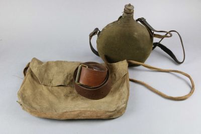 pair of military canteens with leather straps and a canvas bag