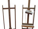 two wooden easeels with a lamp on top of them