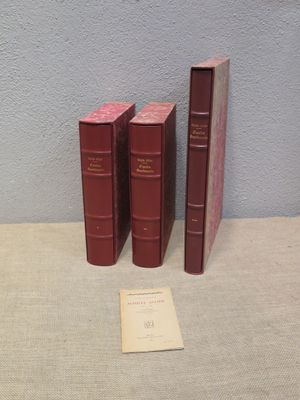 three books sitting on a table next to each other