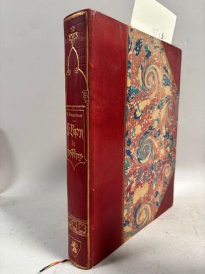 un vieux livre à la couverture rouge posé sur une table