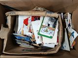 a cardboard box filled with many different types of papers