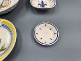 many plates and bowls that are on the table
