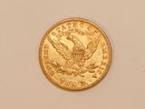 an image of a gold coin on a white surface