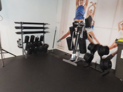 a gym room with weights, dumbs, and other equipment