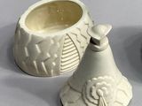 two white vases sitting next to each other on a table