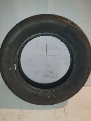 tire on the wall of a building with a hole in it