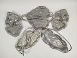 five pieces of silver metal on a white surface