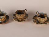 three pieces of pottery sitting on top of each other on a table