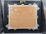 a picture of a piece of wood in a black frame