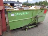 a green dumpster sitting in the middle of a parking lot
