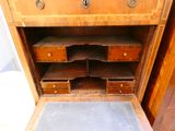 a wooden cabinet with drawers and a rug on the floor